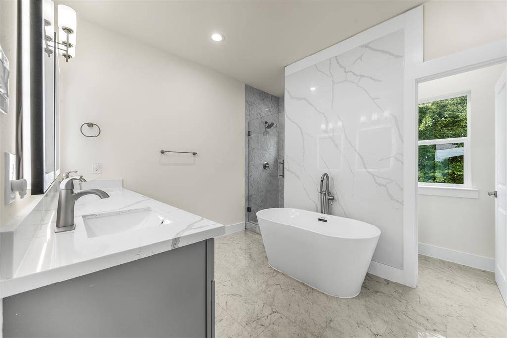 Master Bathroom has a soaker tub, dual sink vanities with luminated mirrors