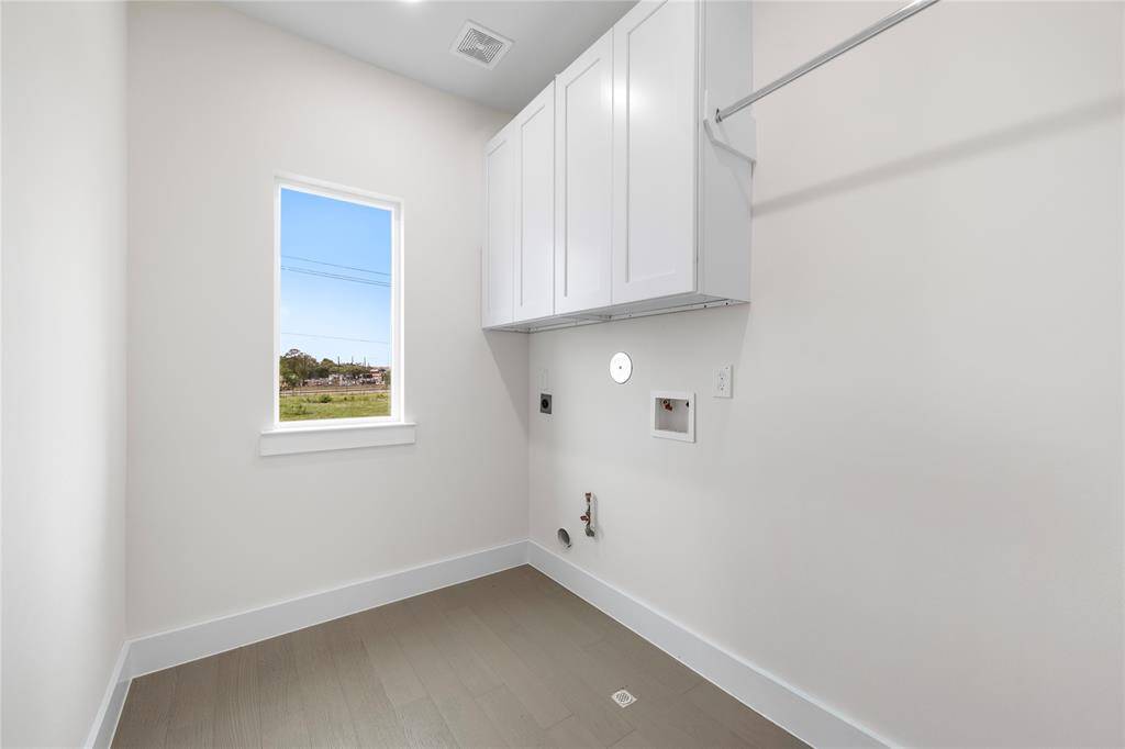 Utility room is upstairs with window view while doing laundry