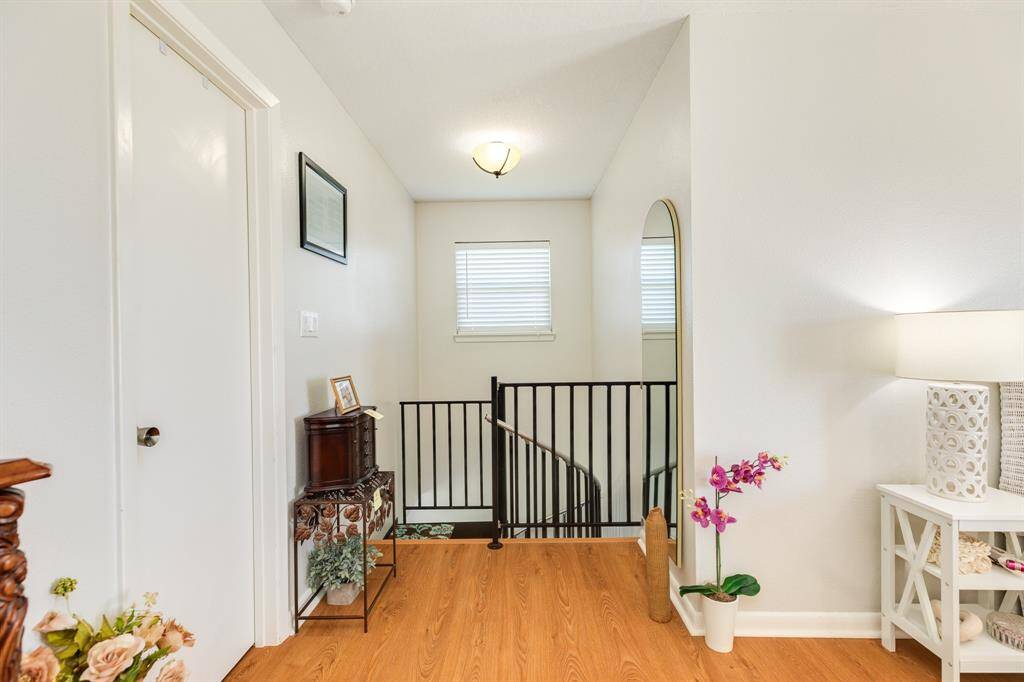 Bright and airy upstairs landing with spiral stair flair.
