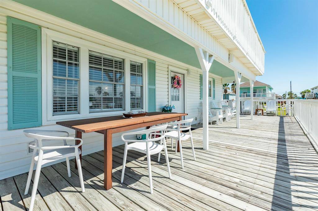 Enjoy coastal dining al fresco on this spacious deck, featuring a sleek wood table and stylish seating. A perfect spot to savor sunsets or sip your morning coffee.