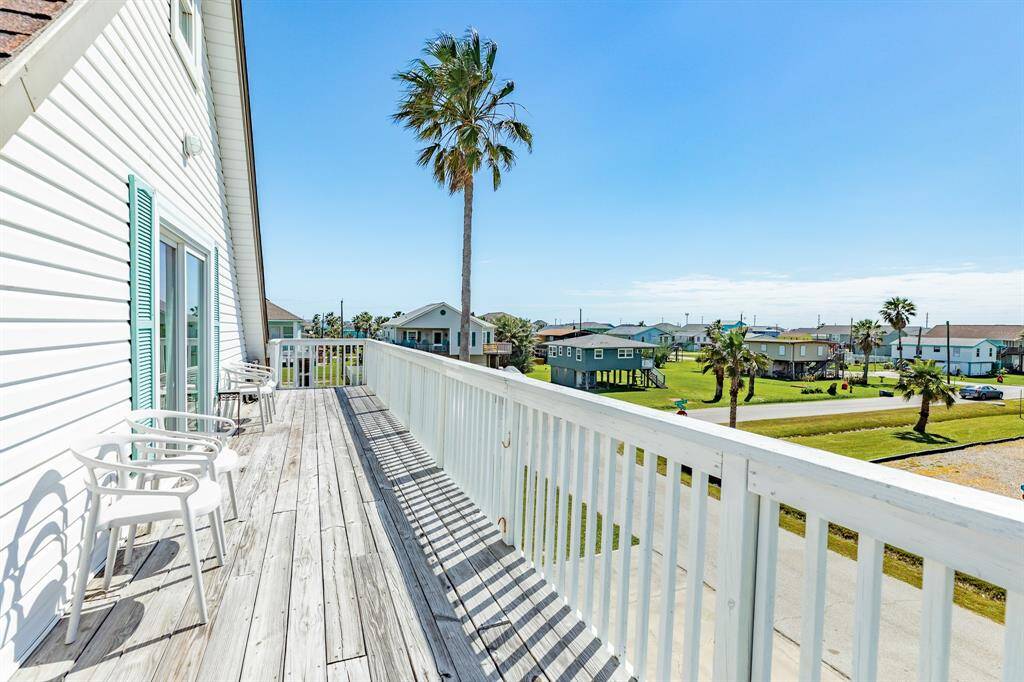 Perched high on the second level, this upper deck offers sweeping views of the neighborhood, distant glimpses of the Gulf, and a peaceful spot to unwind.