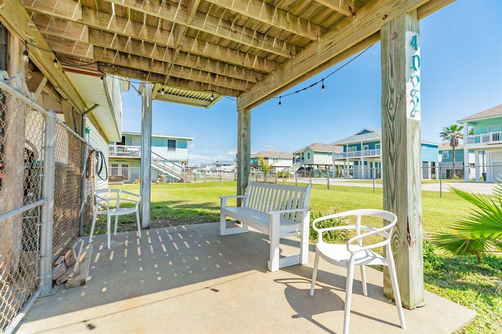 Unwind in this additional covered patio corner, complete with bench seating and views of the open lawn. Whether you're stargazing or sharing stories, it's a favorite perch to enjoy the island air.