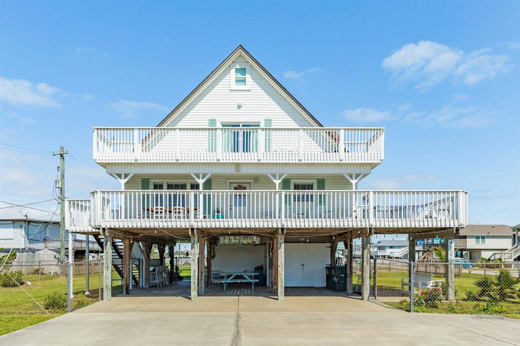 A classic beach house with double large decks offering ample outdoor space. The large driveway and shaded ground-level area make this home as practical as it is charming.