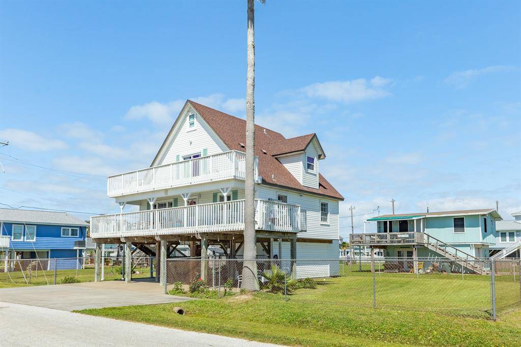 A fully fenced yard surrounds the home, offering a safe space for pets or play. With a second-story balcony and top-floor dormer, this house stands tall with character and functionality.