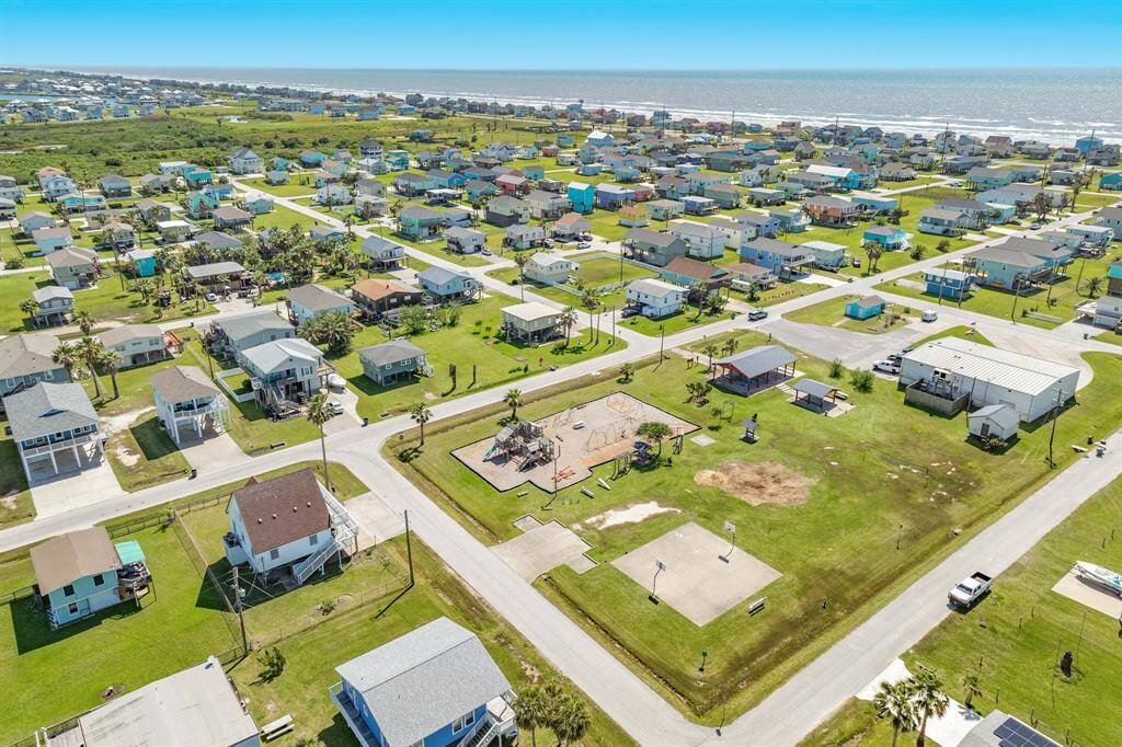 The red arrow highlights the home's proximity to the playground and beach access. Everything is just a short stroll away, making this location ideal for families or short-term rental guests.