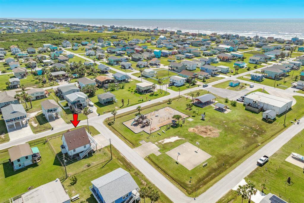An impressive aerial perspective showcases the vibrant coastal community just moments from the water. Notice the proximity to the shoreline and the peaceful layout of the neighborhood—a perfect blend of beach access and quiet living.