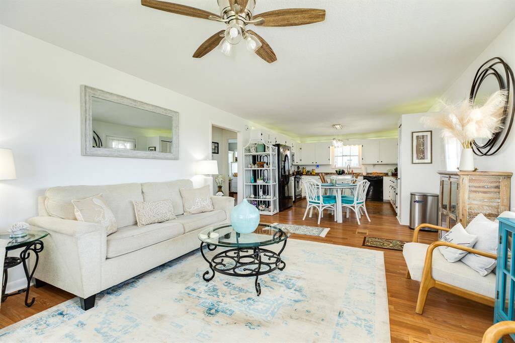 A seamless flow from the living room into the dining and kitchen areas allows for easy entertaining and everyday comfort. The open-concept layout is both functional and inviting.