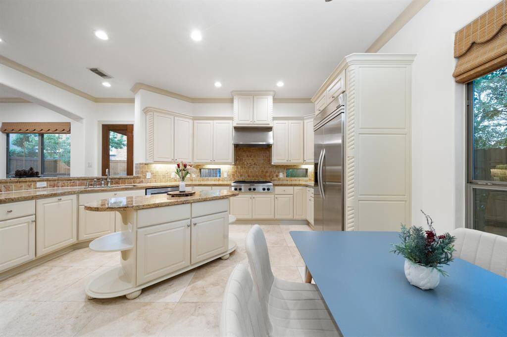 Beautiful open Kitchen with recently resurfaced cabinets and premium stainless steel appliances.