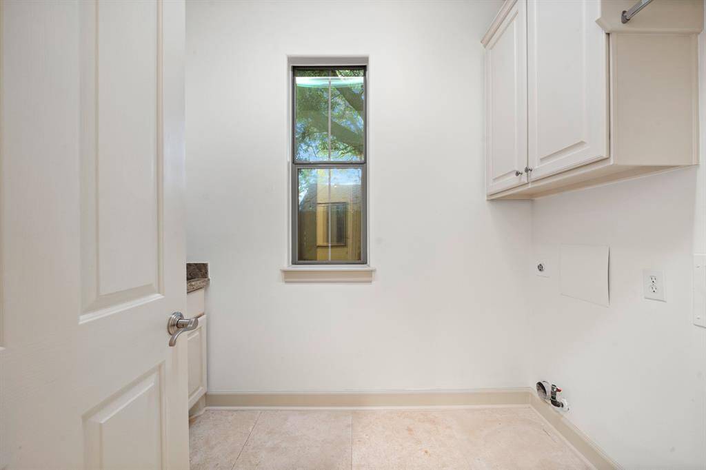 Laundry room with storage cabinets and utility sink