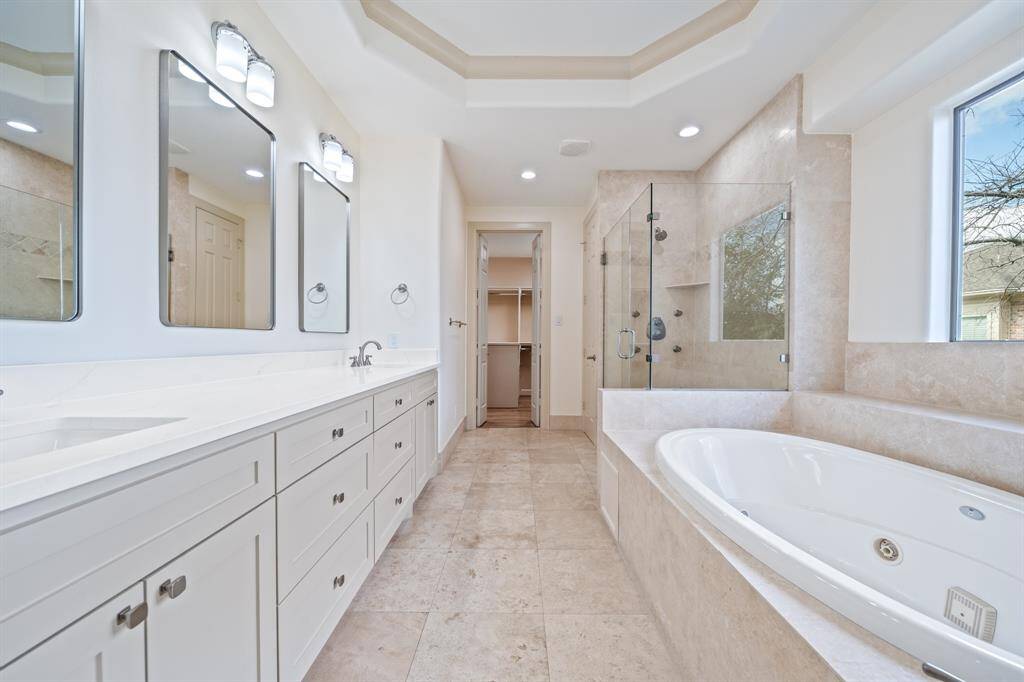 2024 remodelled Master bath features separate vanities, jetted tub and large walk-in shower