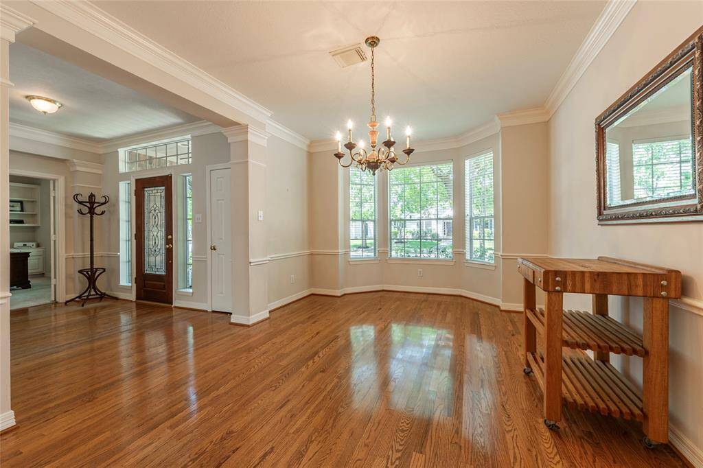 Spacious formal dining with wood floors.