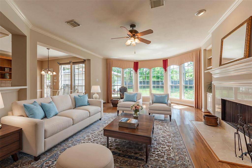 Beautiful family room with open concept, floor to ceiling windows with backyard views and wood flooring.Virtually staged.
