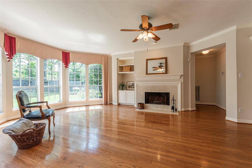 Fireplace with ceramic tile surrounding, mantel and built in book shelves.