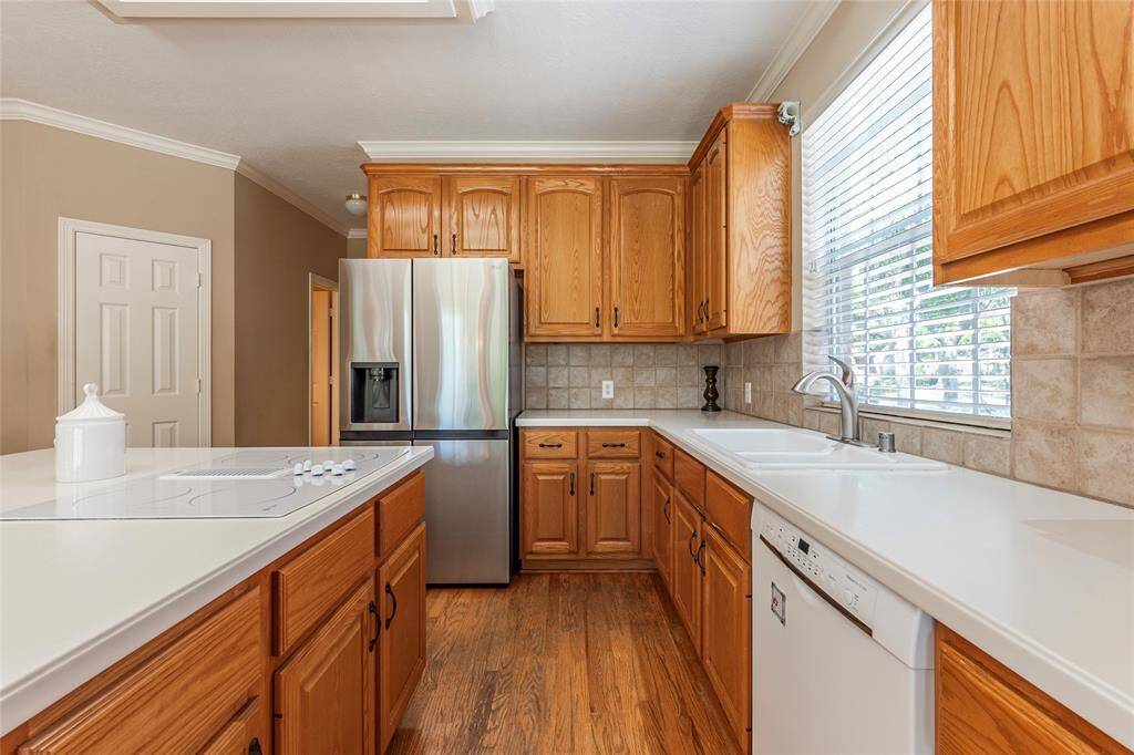 Refrigerator included. Ample counter top space with double sink and built in cooktop.
