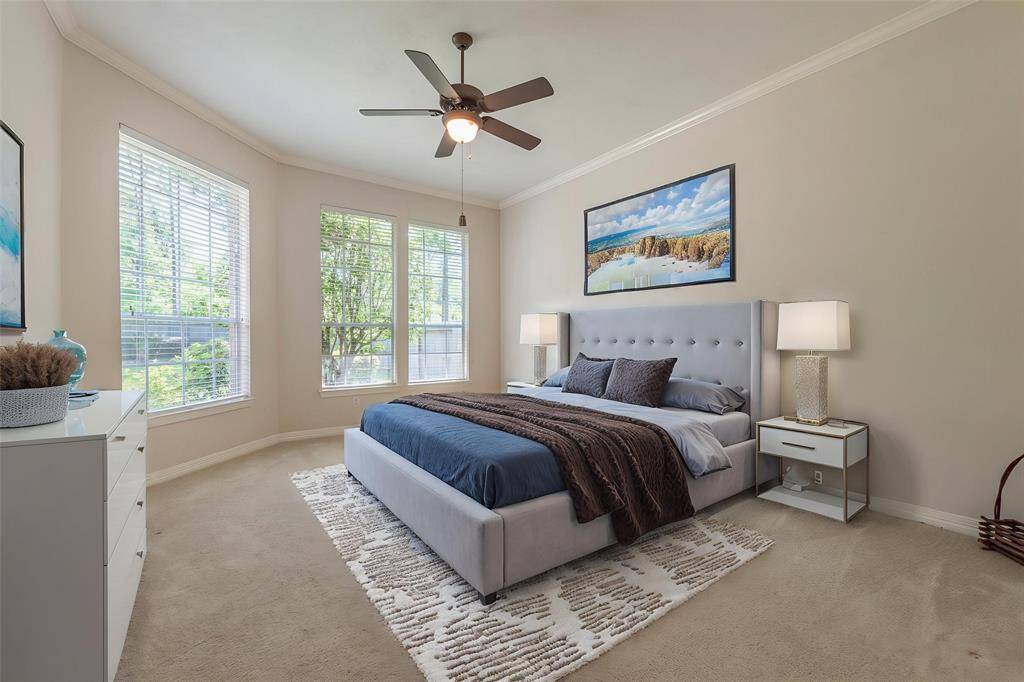 Virtually staged primary bedroom with great natural lighting and high ceilings.