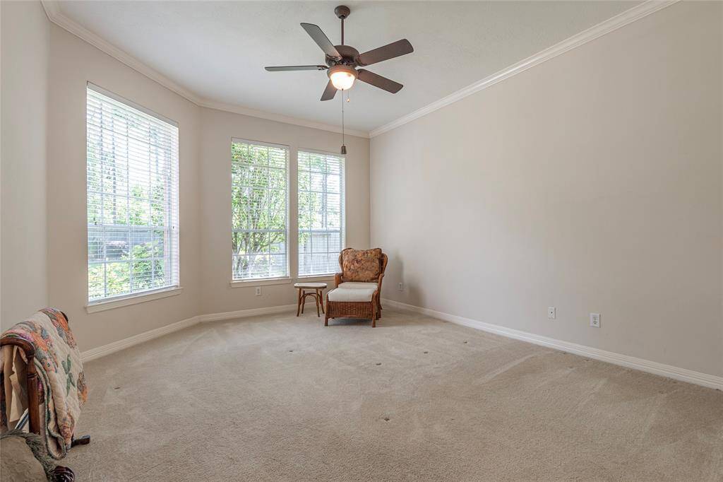 Another view of the primary bedroom with crown molding.