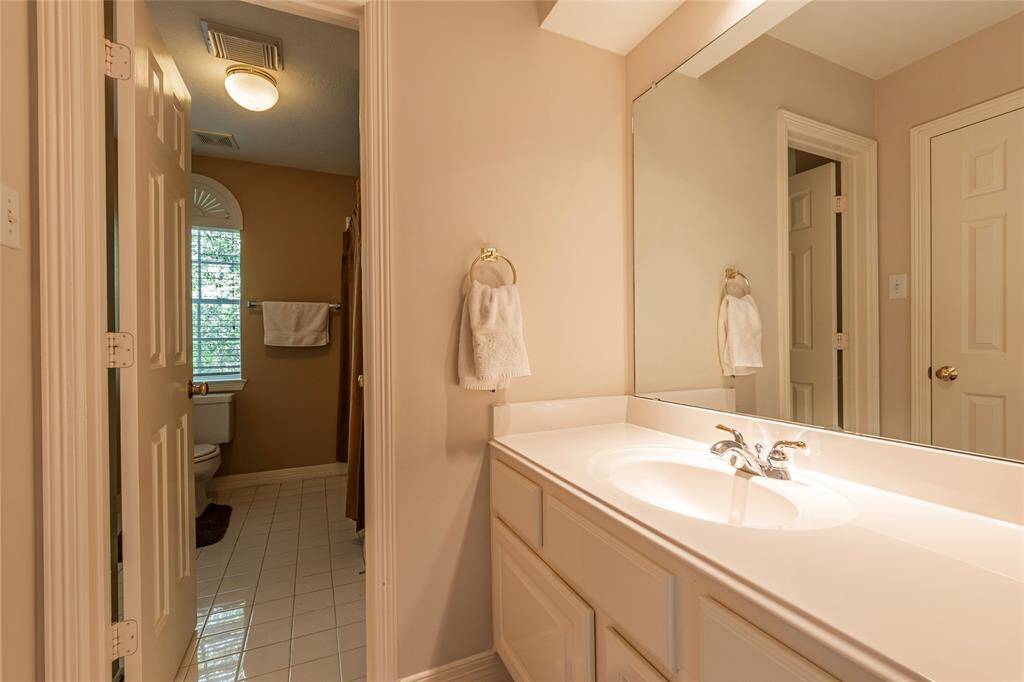 Vanity area of the Jack and Jill bath that shares a shower/tub combo.