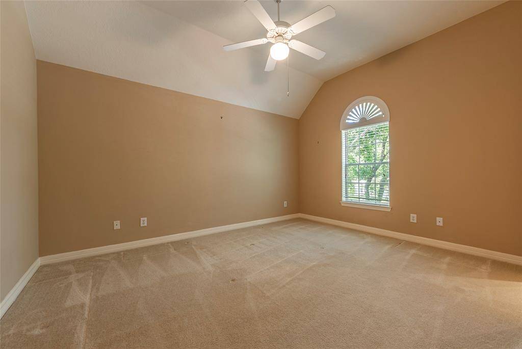 Huge spare bedroom with high ceilings.