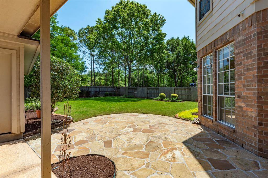 Stone patio looks out into the large backyard.