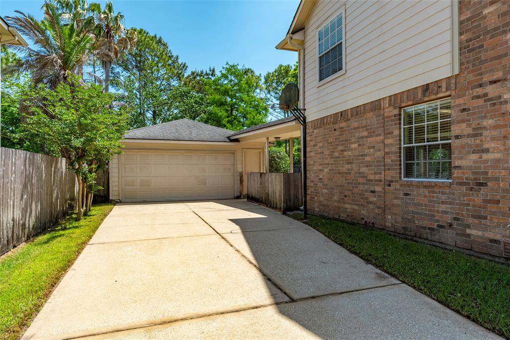 Wide driveway and two car detached garage.