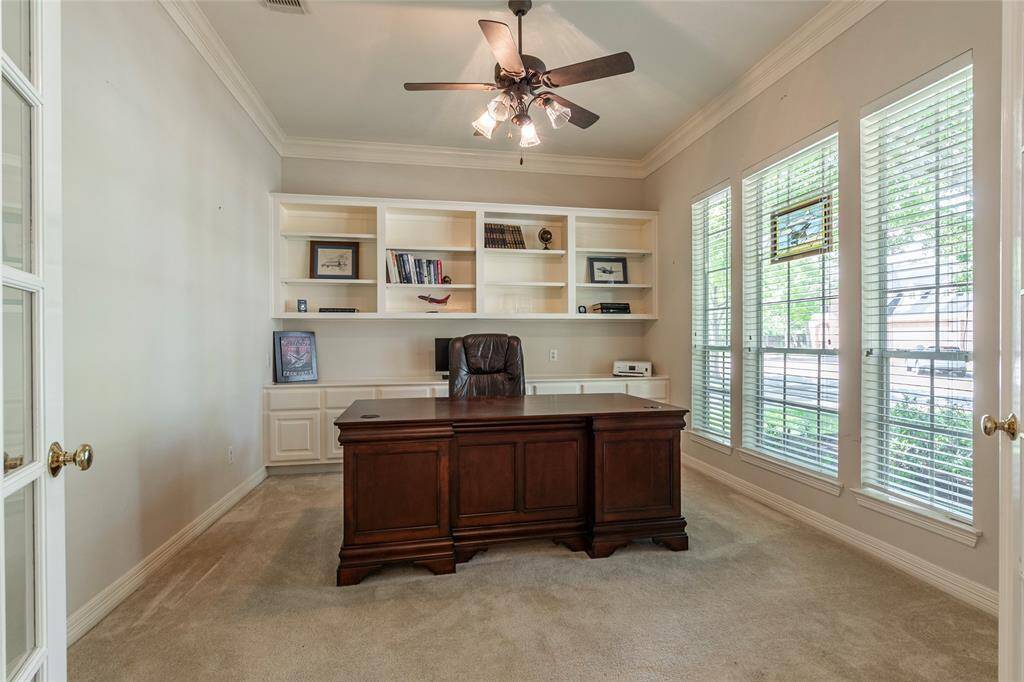 Home-office at the front of the home with built ins, french doors, and great natural lighting.