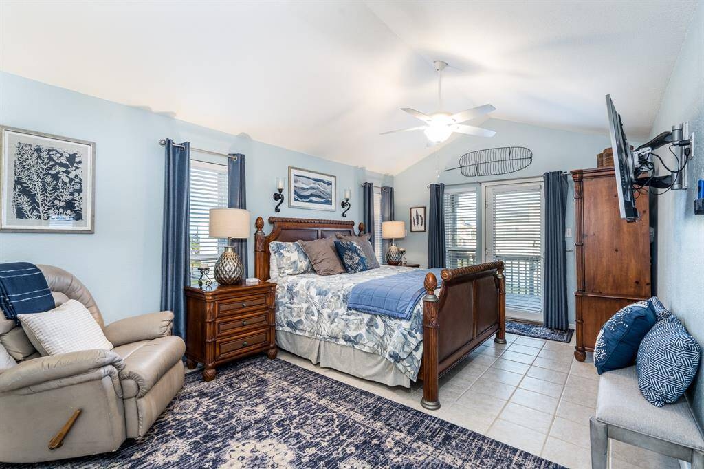 The spacious primary bedroom on the second floor offers access to both front and back balconies, perfect for enjoying breathtaking sunrise and sunset views.