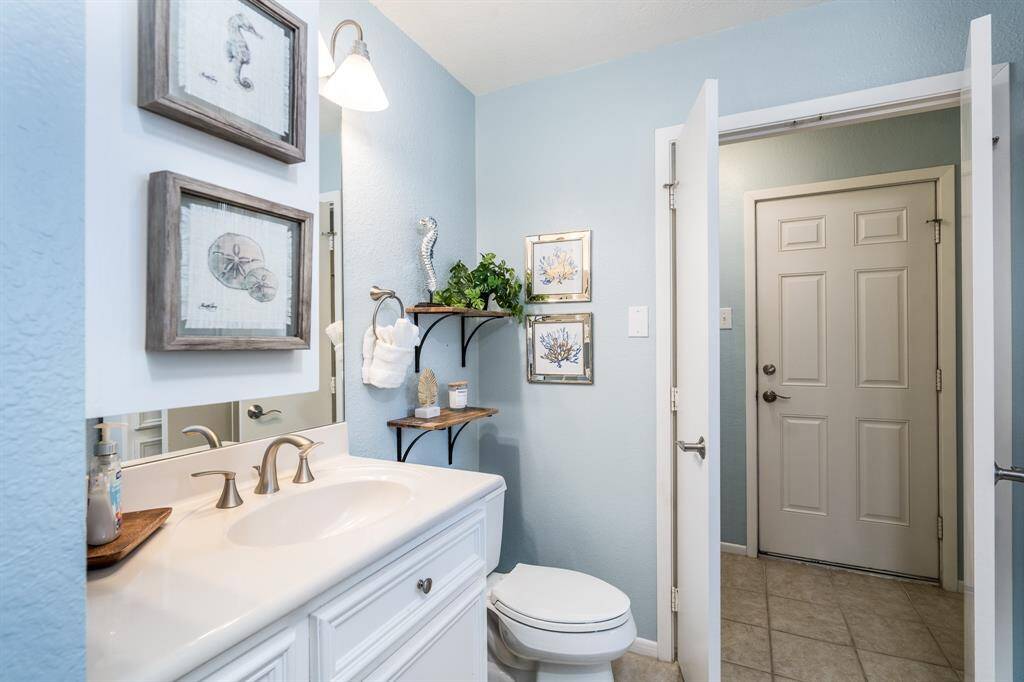 The primary bath offers extensive storage options, along with direct access to the balcony hot tub, combining convenience and luxury in one seamless space.