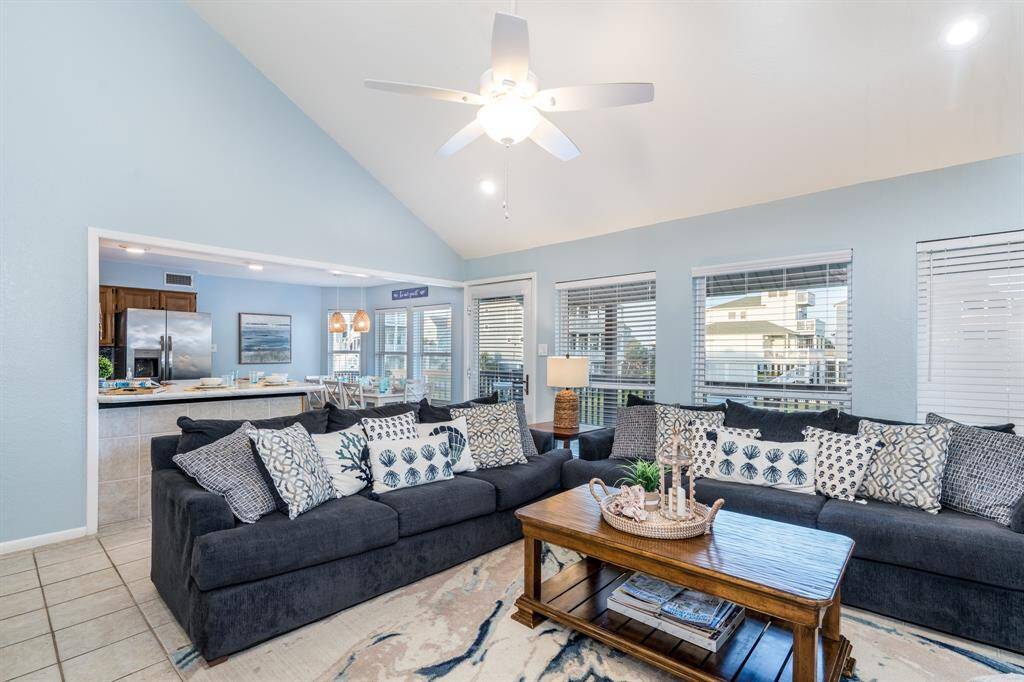 The spacious living room flows seamlessly into the kitchen and dining areas, offering plenty of room to accommodate even the largest of families with ease and comfort.