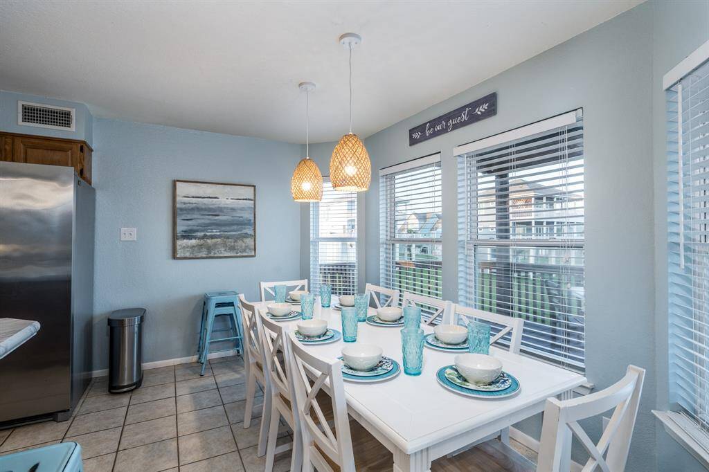 The sunny, open dining room offers abundant natural light and plenty of space to seat a crowd—perfect for family gatherings or holiday feasts.