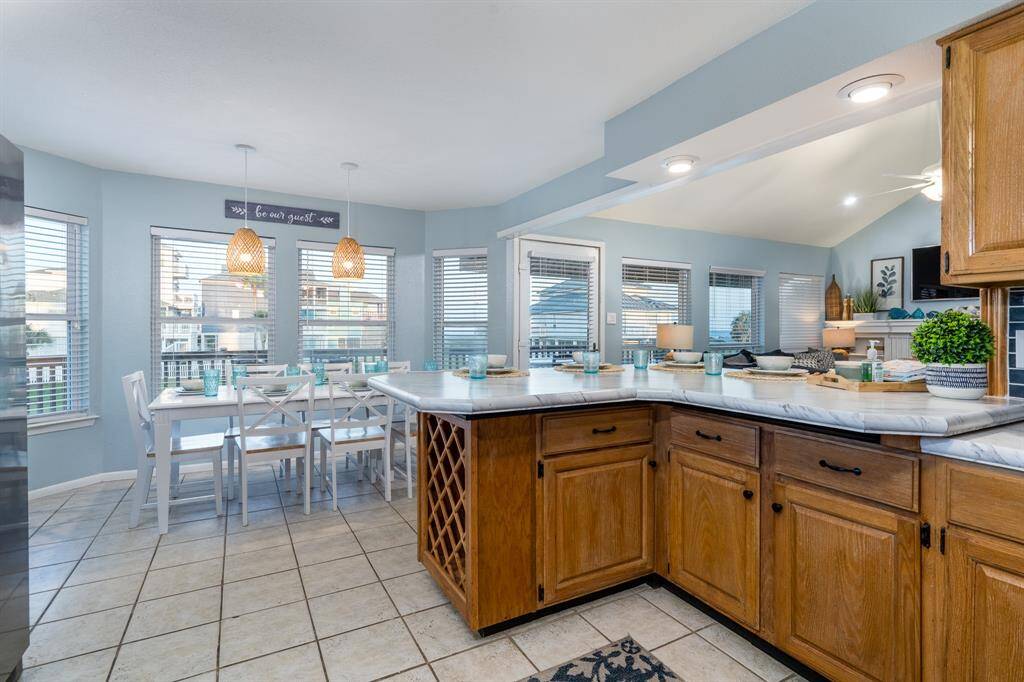 The breakfast bar seamlessly connects the kitchen to both the dining and living rooms, creating an open, social space for entertaining and family gatherings.