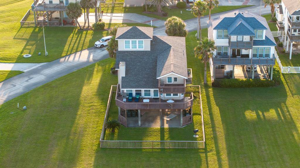 Elevated view of the fenced property offering both privacy and panoramic ocean vistas.