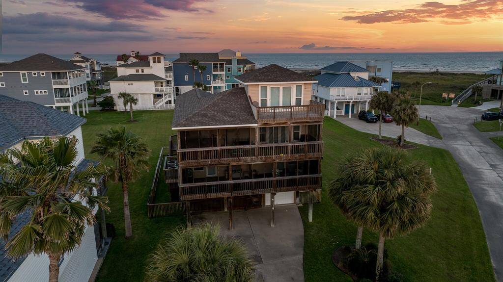 The home glows against a backdrop of soft evening light and coastal serenity.