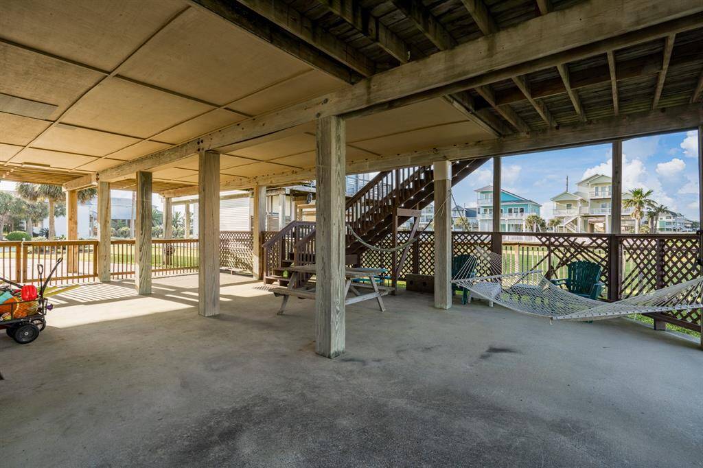 Enjoy expansive covered outdoor living on the ground level, perfect for shaded gatherings, grilling, or lounging after a beach day.