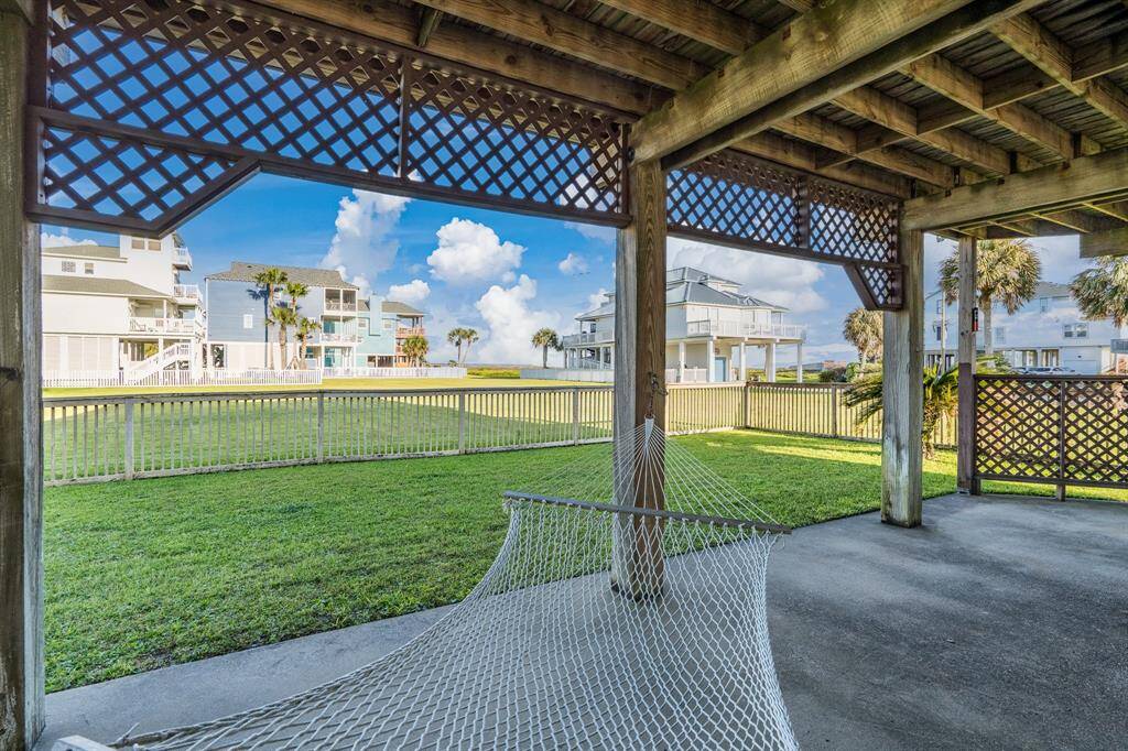 Swing gently in the hammock as you keep watch over the fun happening in the fenced yard below—laid-back living at its best.