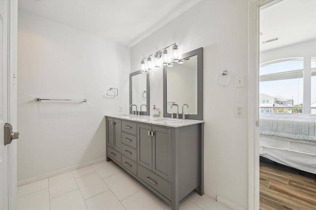When you enter the ensuite bathroom, you will be delighted by its details.  It has a luxurious double vanity and large, glass-enclosed shower.