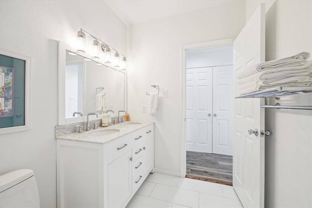 The second double vanity bathroom located on the first floor.  This room services guests and one of the secondary bedrooms.