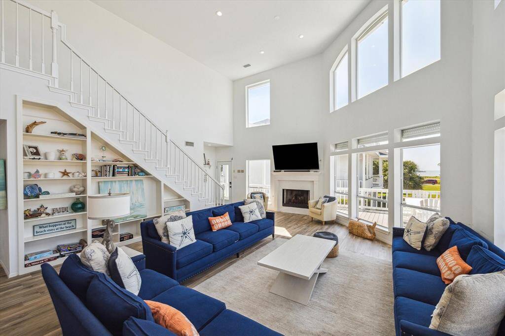 The 2-story ceiling really makes this space feel grand.  Notice the ocean view through the widows.