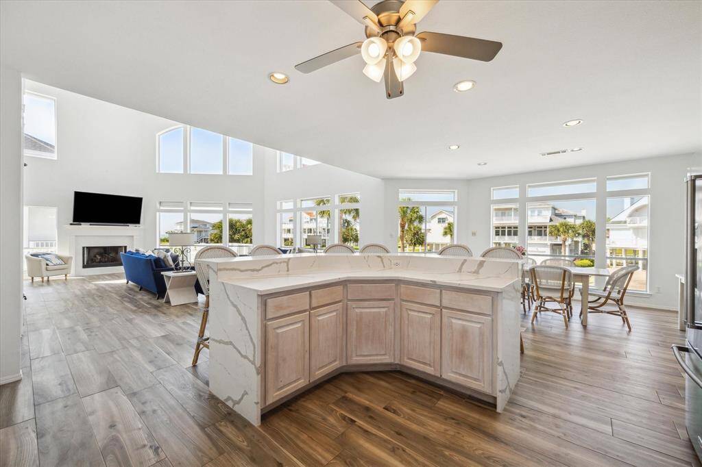 Large kitchen island featuring waterfall quartz counters with seating for 6.  Comfortable flow to the living and dining room.