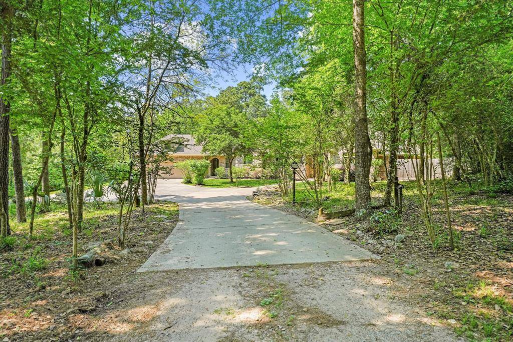 About halfway down the driveway, the home begins to come into view.  The driveway wraps around to the left and can lead back to the street without having to turn around.