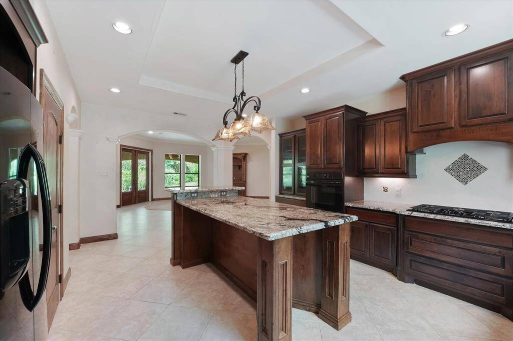 This view of the kitchen is from the sink looking back towards the living area and the rear of the house.  To the right is the gas cooktop.
