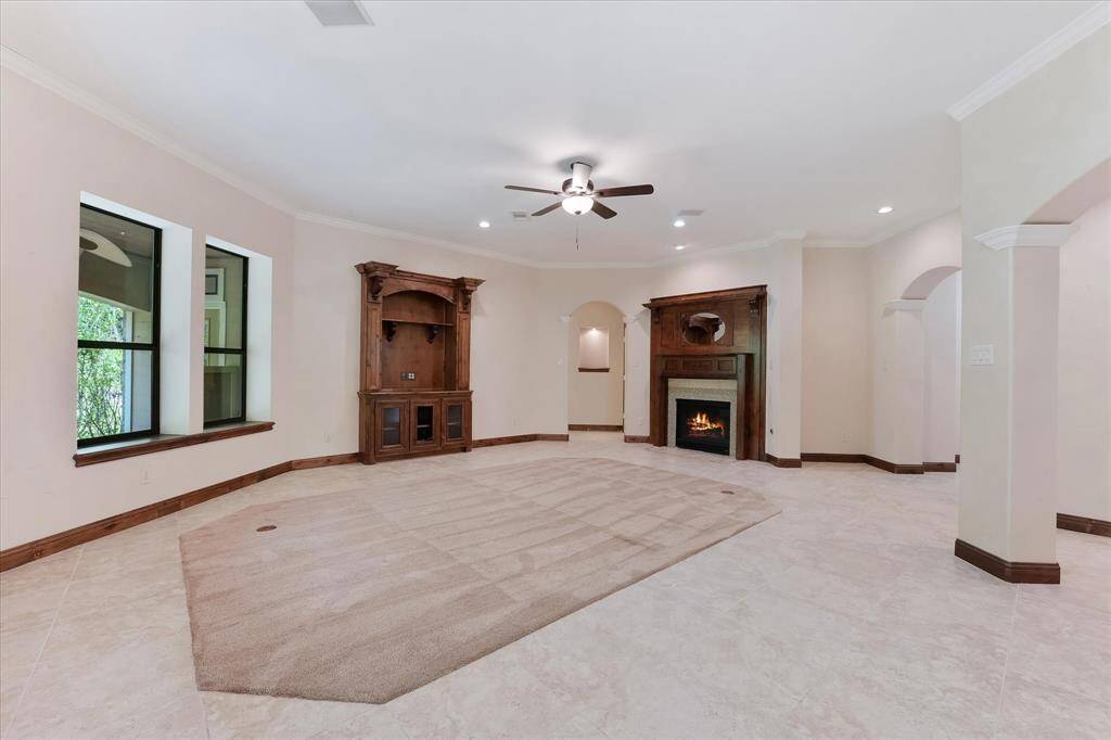 The main living area is set at the center of the house and features tons of space, in-floor electrical outlets, and a gaslog fireplace.