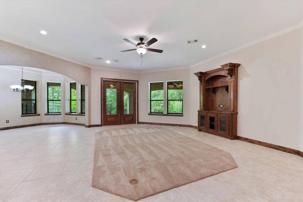 Looking from the fireplace towards the back of the house, we can see how large this room is, and a good look at the stately built-in entertainment center. The formal dining area is to the left.
