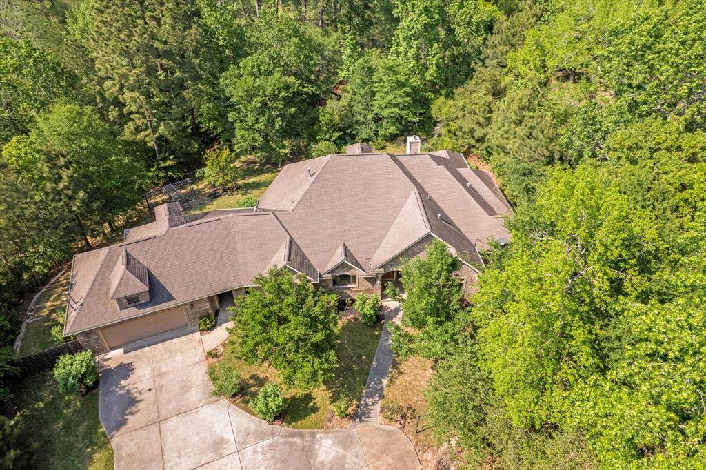 Ariel view of the home showcasing the wooded 1.38 acre lot.  Peace and quiet and privacy abound!
