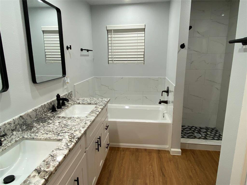 Primary bath has separate shower and a large soaking tub