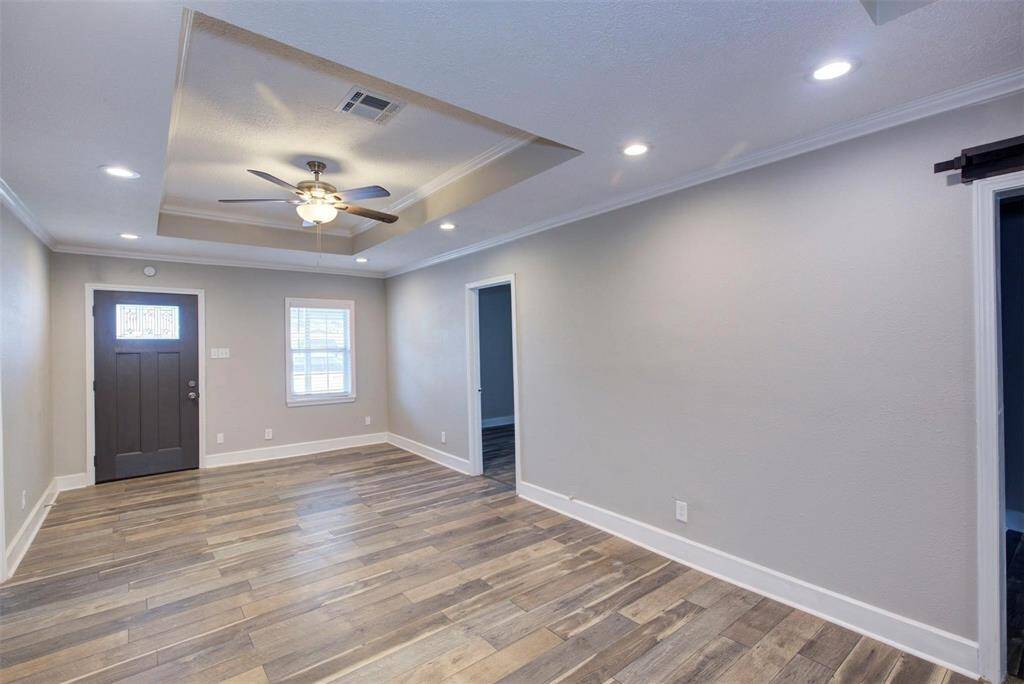 living room featuring a tray ceiling