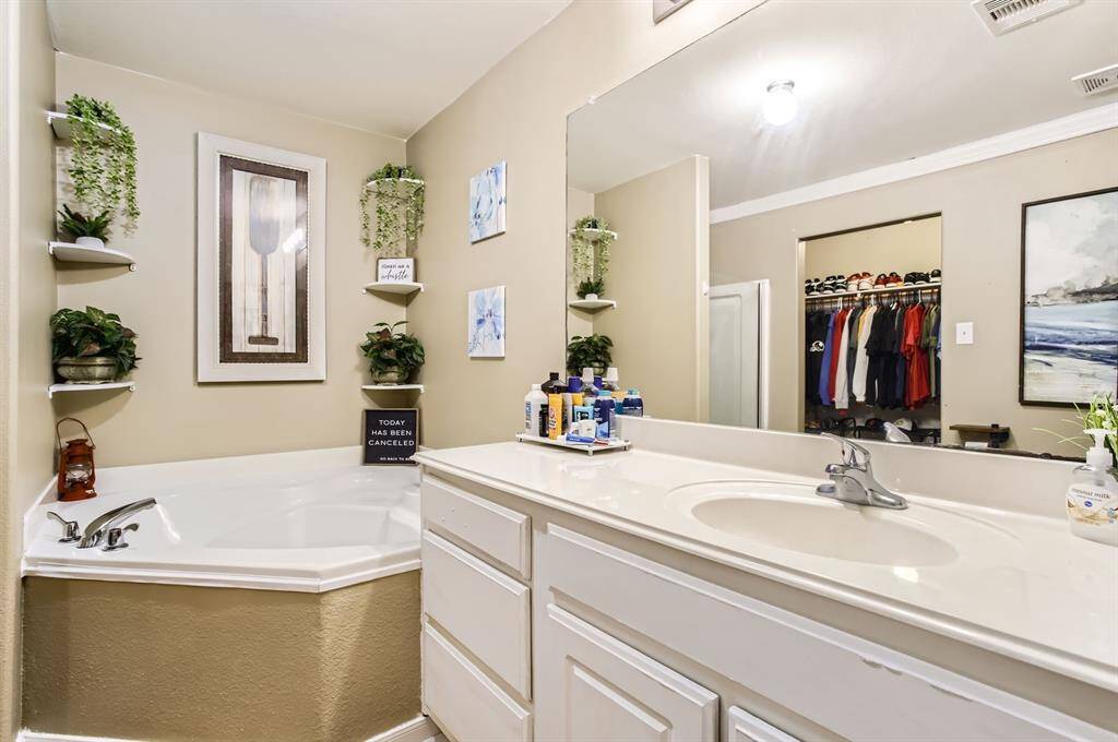 The primary bathroom has plenty of counter space with seperate soaking tub and shower.