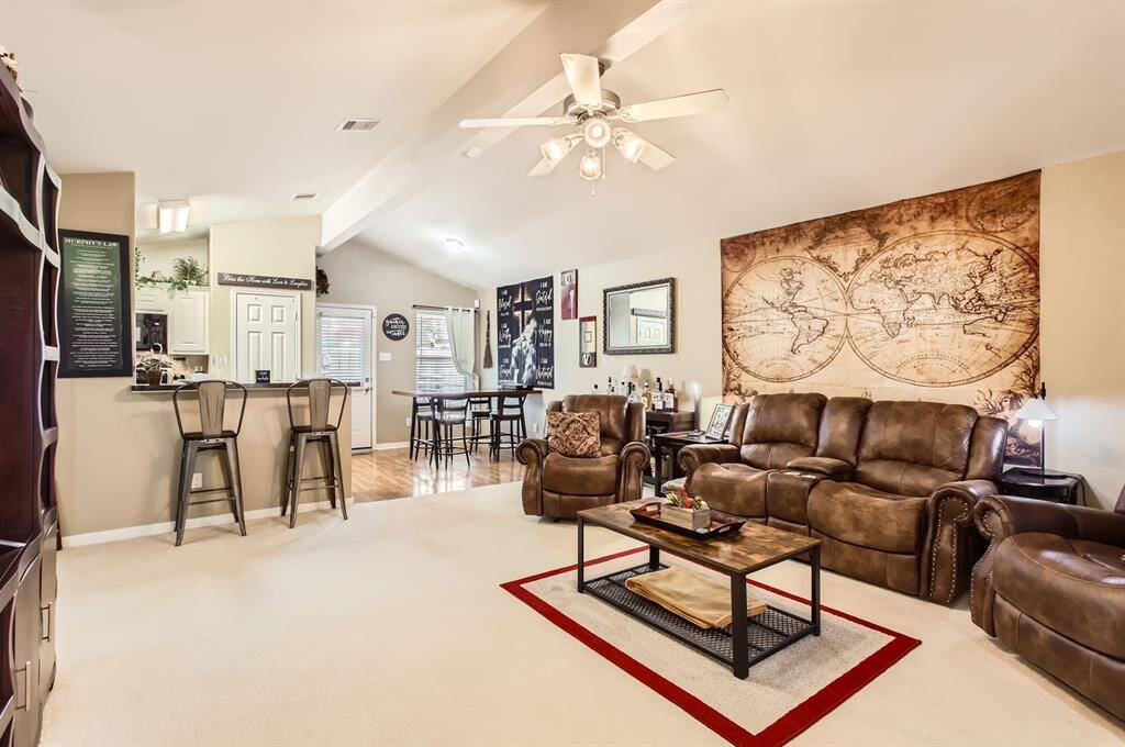 Tne spacious family room has vaulted ceilings and is open to the kitchen and dining area