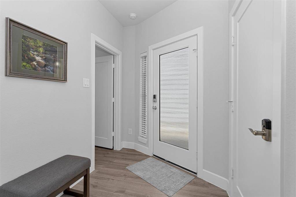 Front entry.  Garage door to the right.  Bedroom and bathroom to the left.
