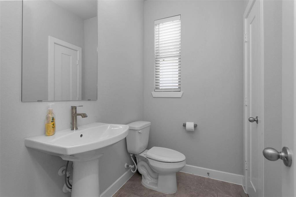 Half bathroom upstairs with a storage closet