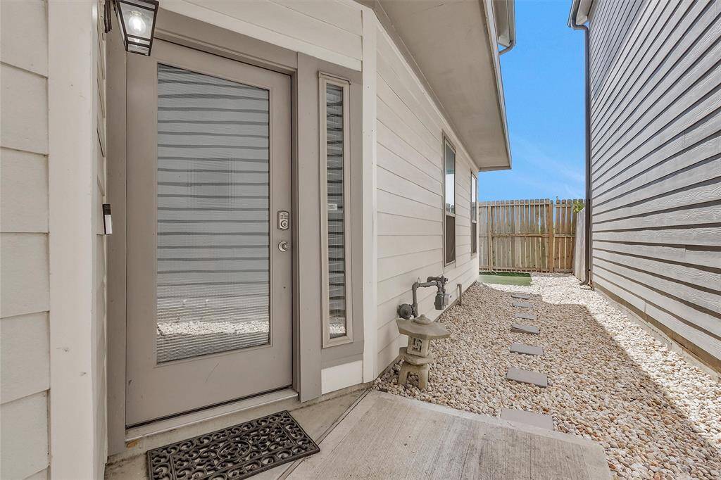 Low maintenance yard with gravel leading to the back yard